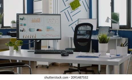Empty financial office room with wheelchair for disabled paralyzed invalid people in business company workplaced next desk. Modern workspace with nobody in, computer with economic statisctics