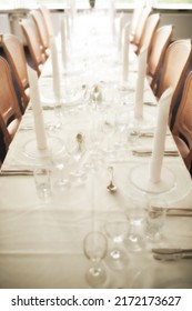 Empty Fine Dining Room Table Arranged For Dinner In Fancy Restaurant. Above View Of Glass Dishes, Cups, Wineglasses, Silverware And Cutlery Neatly Organized For Lunch. Seating In Hospitality Industry