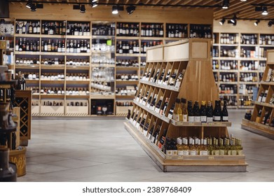 Empty fine modern wine aisle rows in alcohol beverage department at supermarket store grocery shop inside hypermarket. Purchasing food gastronomy, urban lifestyle, consumerism and marketing concept