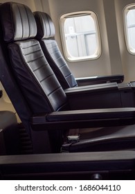 Empty First Class Window And Aisle Seat During The Coronavirus Pandemic. Airline Industry Struggles As Americans Are Told To Stay Home To Slow The Spread Of The Disease