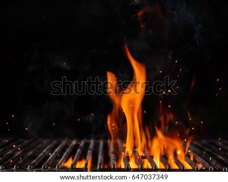 Empty flaming charcoal grill with open fire, ready for product placement. Concept of summer grilling, barbecue, bbq and party. Black copyspace