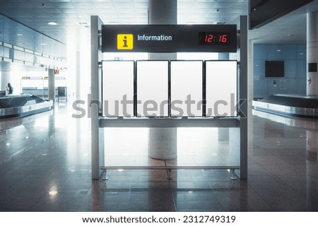 Empty flight information mock-up boards in Barcelona airport. Standing against a column, bathed in bright white light, awaiting passengers' attention