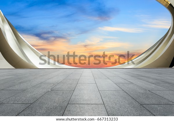 Empty floor and\
modern architecture at\
sunset\
