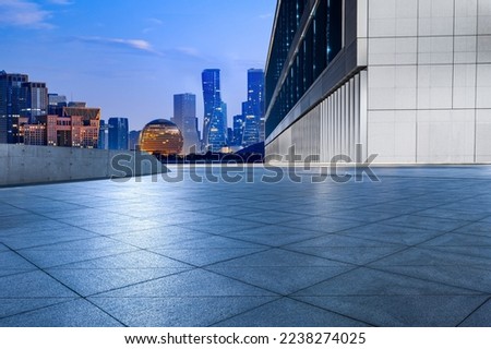 Empty floor and modern city skyline with building at sunrise in Hangzhou, China. 