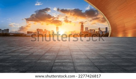 Empty floor and modern city skyline with buildings at sunset