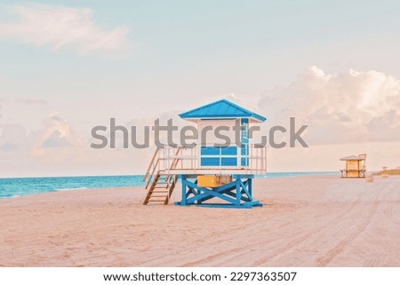 Empty Florida beach with lifeguard houses on sunset. Airy light nature