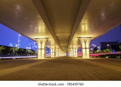 empty footpath below elevated road in modern city