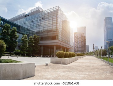 Empty Footpath With Modern Office Building Exterior  And Blue Cloudy Sky During Sunrise