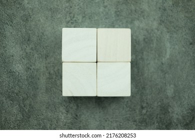 Empty Four Wooden Blocks Stacked In Two Rows Combined Into A Big Square On A Black Background.