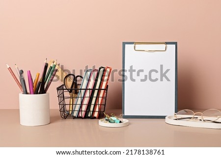 Empty frame mockup, desktop organizer with school stationary and office supplies. Back to school, home office, begining of studies concept
