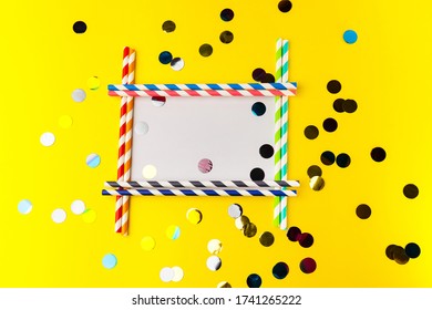 Empty Frame From Multi-colored Biodegradable Paper Tubes With Place For Your Text. The Concept Of Party, Celebration, Birthday. Copy Space On Yellow Background With Multicolored Foil Confetti.