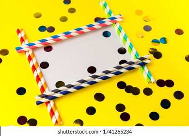 Empty Frame From Multi-colored Biodegradable Paper Tubes With Place For Your Text. The Concept Of Party, Celebration, Birthday. Copy Space On Yellow Background With Multicolored Foil Confetti.