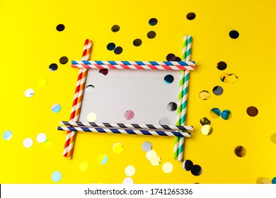 Empty Frame From Multi-colored Biodegradable Paper Tubes With Place For Your Text. The Concept Of Party, Celebration, Birthday. Copy Space On Yellow Background With Multicolored Foil Confetti.