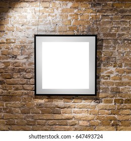 Empty Frame On Light Brick Wall. Blank Space Poster Or Art Frame Waiting To Be Filled. Square Black Frame Mock-Up