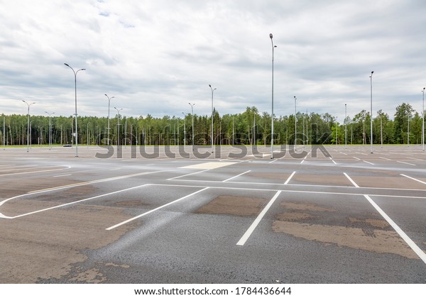 Empty free outdoor parking near the shopping mall on\
a cloudy summer day