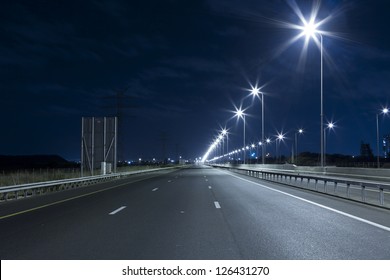 Empty freeway at night - Powered by Shutterstock