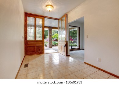 Empty Front Entrance With Open Door. Home Interior With White Walls.