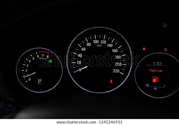 Empty fuel gauge warning light in car dashboard. 
Red warning  light door.