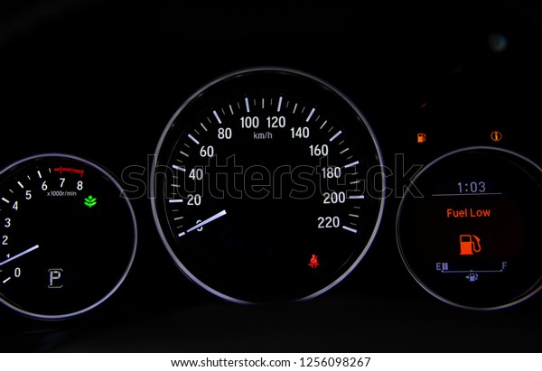 Empty fuel gauge warning light in car dashboard. \
Red warning  light door.