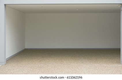 The Empty Garage With White Wall And Sand Wash Floor