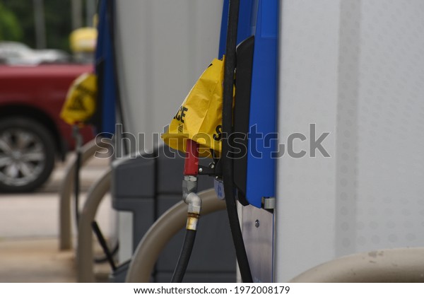 Empty gas pumps at a service station are covered with\
yellow bags after a cyber attack disrupted distribution to the\
Southeast US. 