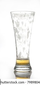 an empty glass of beer isolated on whit with small reflection