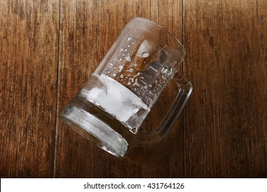 Empty Glass of Beer on the Wooden Table