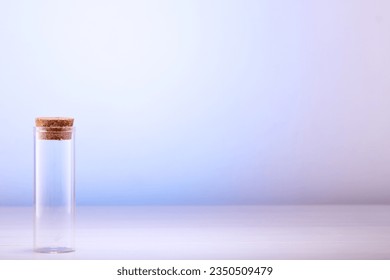 Empty glass bottle with cork on table with space for text.