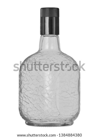 the empty glass bottle with a pattern closed by a cover on a white background