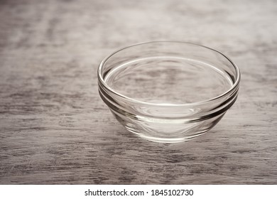 Empty Glass Bowl On A White Wooden Background.