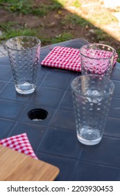 Empty Glass Cups On Plastic Table Outside