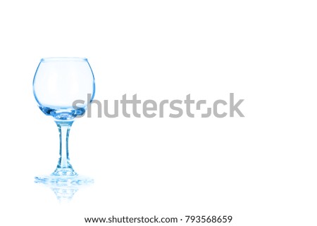 An empty glass of liqueur or vodka toned in blue colorisolated on a white background. Place for your text.