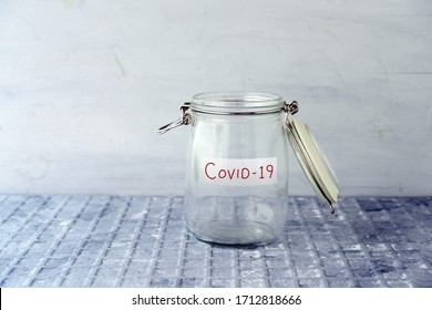 Empty Glass Money Jar With Covid19 Label, Financial Concept.