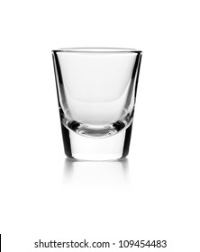 Empty glass on a reflective surface on white background