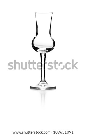 Empty glass on a reflective surface on white background
