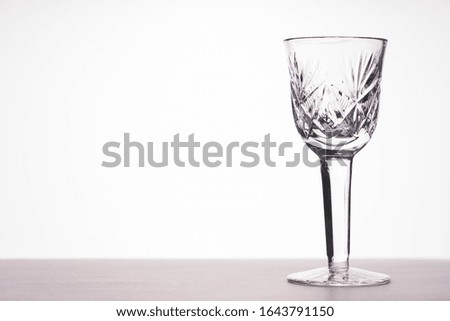 empty glass on the table on a white background, tinted image, selective focus, vignetting