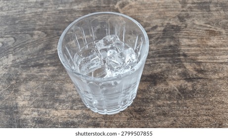 Empty glass with solid ice cubes ready for drinks, perfect for cafe menus, restaurant promotions, and beverage blogs.