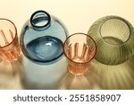 Empty glass vases on beige background, above view