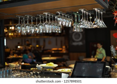 Empty glasses await customers in the bar. - Powered by Shutterstock