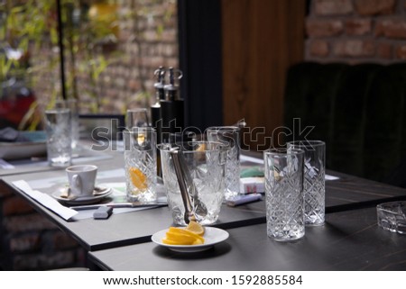 Empty glasses on a table in a restaurant; after drink concept; selective focus background.
