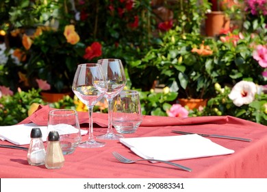 Empty Glasses Set In Street Terrace Of Restaurant, Provence, France.