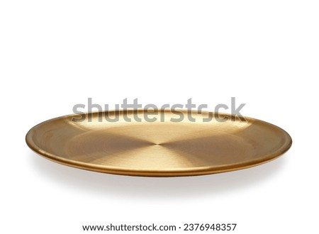 Empty golden plate isolated on white background with clipping path. Front view of gold round flat plate with shadow. Mock up template for food poster design.