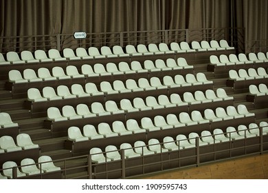 An Empty Grandstand With White Seats In The Indoor Arena Of The Equestrian Club. Russian Inscription 