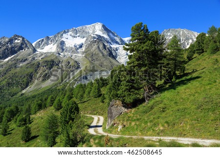 Empty gravel road in the beautiful mountains of Wallis, Switzerland.