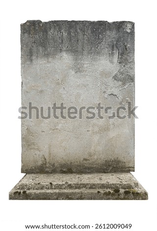 Empty gravestone - gray stone wall displays a surface with wear, including stains and unevenness. Natural weathering gives it a aged appearance, for various contexts. Isolated tombstone, copy space