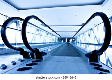 Empty gray escalator view in blue corridor in office centre