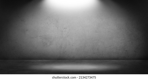 Empty gray floor and blank dark grey concrete wall in spotlit light interior garage studio room. Copy space or product display. - Shutterstock ID 2134273475