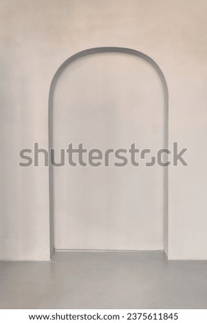An empty gray interior room with a recess in the back wall, modern architecture or the background of a product presentation template. High quality photo