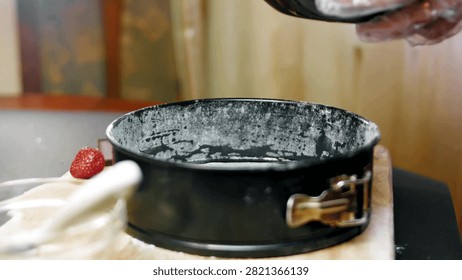 Empty greased springform pan prepared for chocolate cake batter