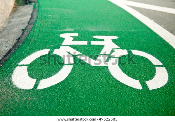 Empty green cycle\
track with bike lane sign